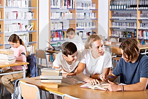 Teenagers spending time in library