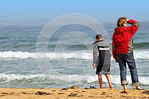 Teenagers on the spring sea beach photo