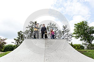 Teenagers standing on a halfpipe