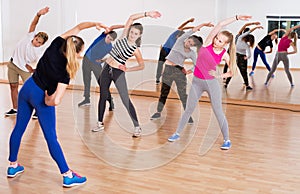 Teenagers stretching in dance hall