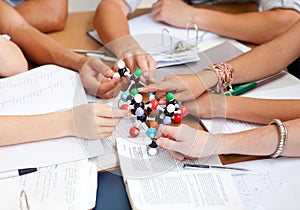 Teenagers studying molecules in a library