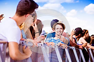 Teenagers at summer music festival, at the barrier