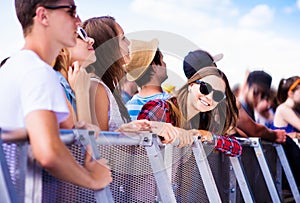 Teenagers at summer music festival, at the barrier