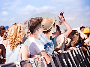 Teenagers at summer music festival, at the barrier