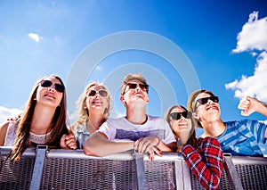 Teenagers at summer music festival, at the barrier