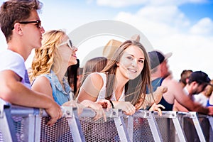 Teenagers at summer music festival, at the barrier