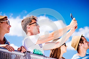 Teenagers at summer music festival in crowd taking selfie