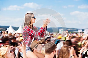 Teenagers at summer music festival enjoying themselves