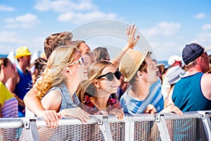 Teenagers at summer music festival enjoying themselves