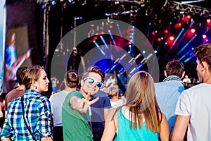 Teenagers at summer music festival having fun