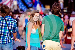 Teenagers at summer music festival having fun