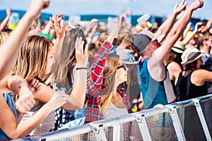 Teenagers at summer music festival having good time