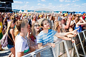 Teenagers at summer music festival having good time