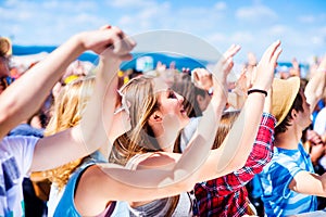 Teenagers at summer music festival having good time