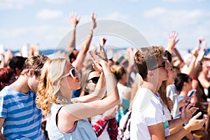 Teenagers at summer music festival having good time photo