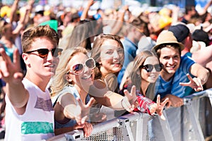 Teenagers at summer music festival having good time photo