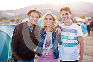 Teenagers at summer music festival, sunset