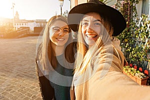 Teenagers taking selfie in sunset - Girls smiling at the camera and having fun