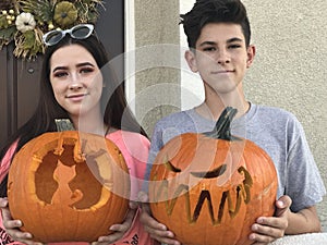 Teenagers with their carved pumpkins at Halloween