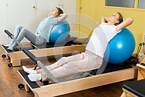 Teenagers training pilates in gym