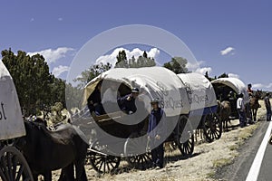 Teenagers traveling on covered wagons