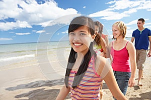 Teenagers walking on beach