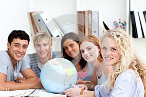 Teenagers working with a terrestrial globe photo