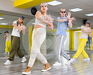 Teenages hip hop dancers doing dance workout during group class