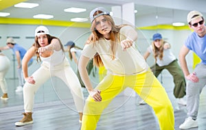 Teenages hip hop dancers doing dance workout during group class