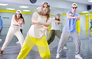 Teenages hip hop dancers doing dance workout during group class