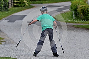 Teenages skating on the street wearing a helmet