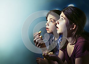 Teens boy and girl watching horror movie film