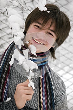 Teens boy with snown branch photo