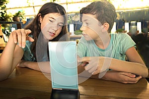 Teens in cafee choosing menu for breakfast photo