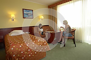 Teens chatting in hotel room