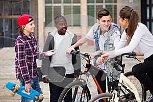 Teens chatting near bikes