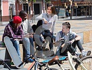 Teens chatting near bikes