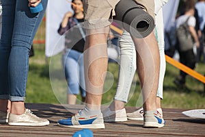 Teens at concert at summer festival. Legs of teenager at summer music festival