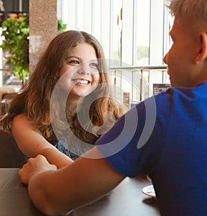 Teens couple in cafe close up portrait