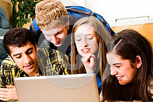 Teens crowd around computer