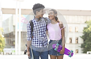 Teens dating in the city walking together outdoors