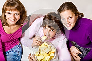 Teens eating crisps