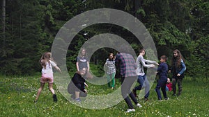 Teens having fun, running in forest.