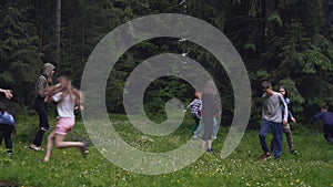 Teens having fun, running in forest.