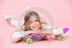 Teens hobby concept. Girl likes to ride skateboard and sporty lifestyle. Girl on smiling face posing with penny board