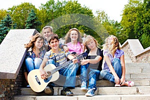 Teens playing guitar