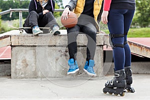 Teens relaxing in skatepark