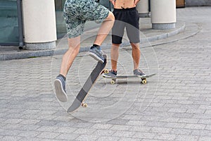 Teens ride a skateboard in the city