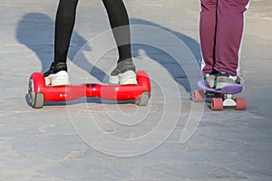 Teens riding gyrometer and skateboard closeup as background