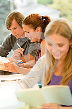 Teens study in high-school library reading student